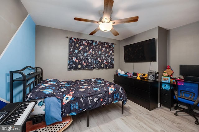 bedroom with a ceiling fan and wood finished floors