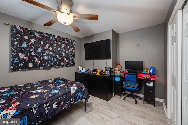 bedroom with baseboards, ceiling fan, and wood finished floors