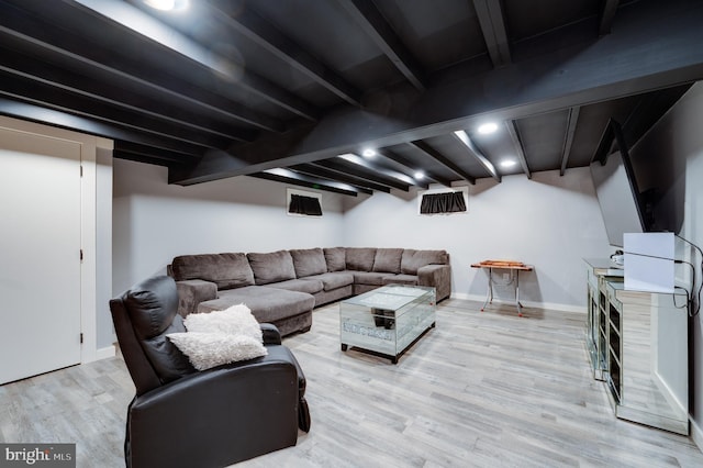living room with beam ceiling, baseboards, and light wood finished floors