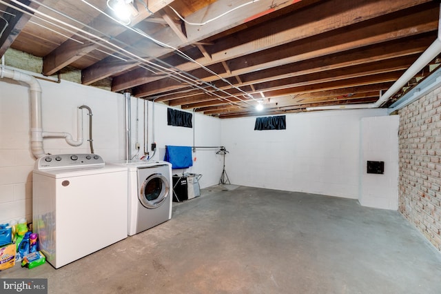 unfinished below grade area featuring separate washer and dryer