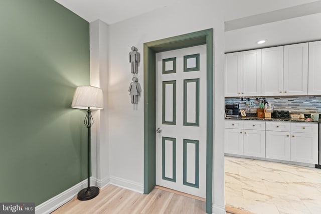 interior space with recessed lighting, light wood-style floors, baseboards, and backsplash