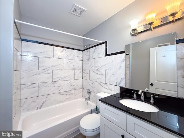 bathroom featuring bathing tub / shower combination, toilet, and vanity