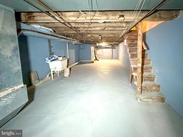 unfinished below grade area with a sink and stairs