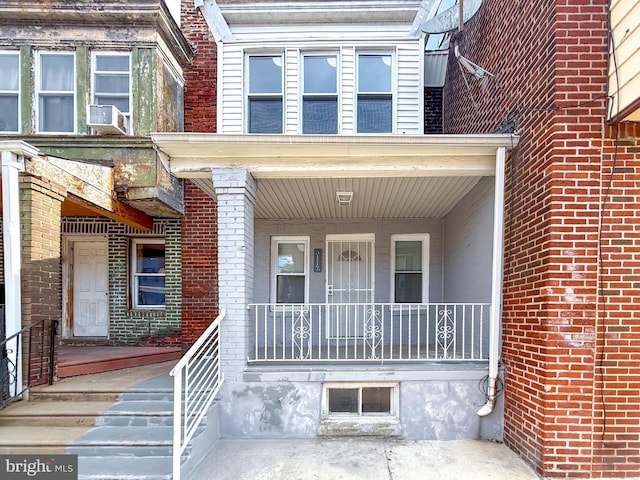 doorway to property with brick siding