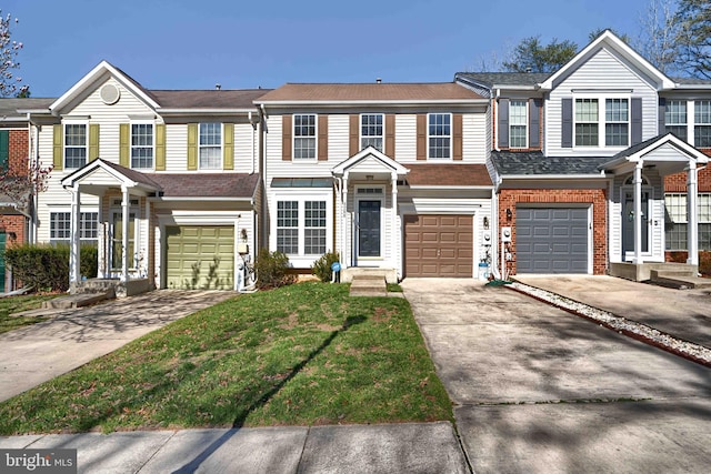 multi unit property featuring a garage, brick siding, and driveway