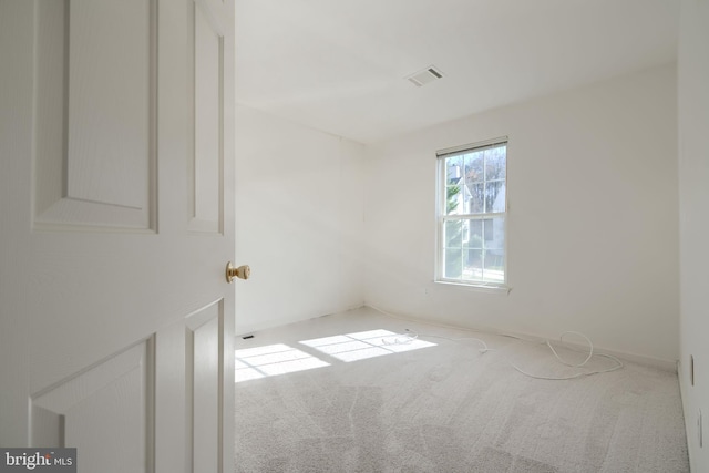 empty room featuring visible vents and carpet floors