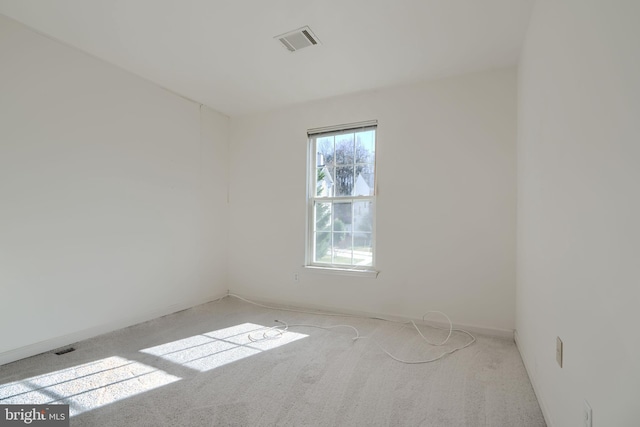 carpeted empty room with baseboards and visible vents