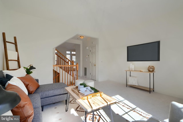 living room with carpet and stairs