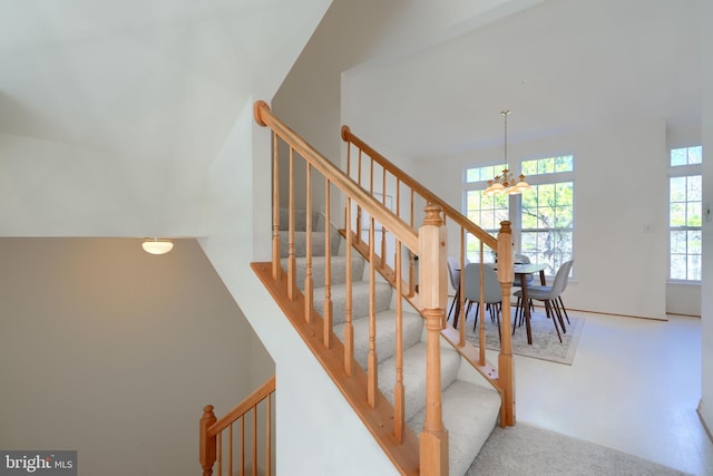 stairway with an inviting chandelier