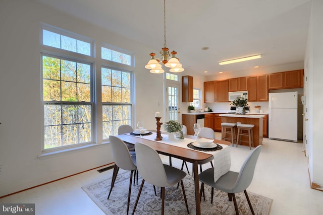 dining room with recessed lighting, visible vents, light floors, and an inviting chandelier
