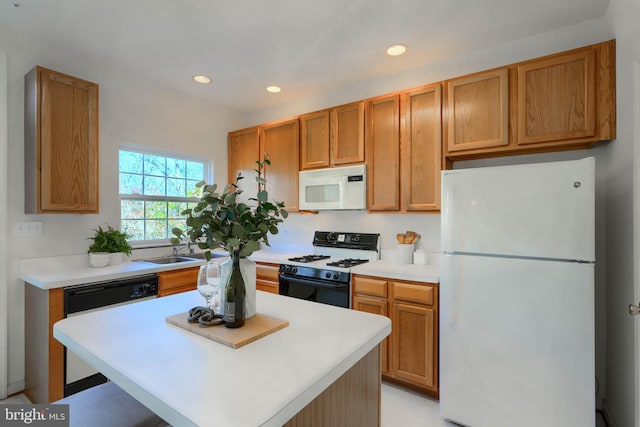 kitchen with white appliances, recessed lighting, and light countertops