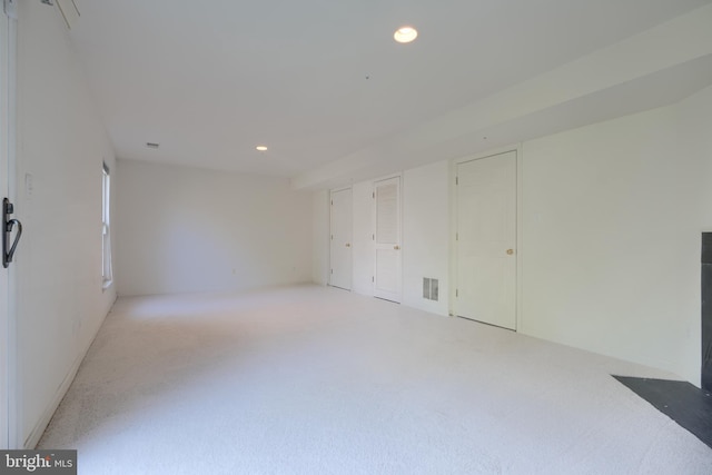 unfurnished room featuring recessed lighting, visible vents, and light carpet