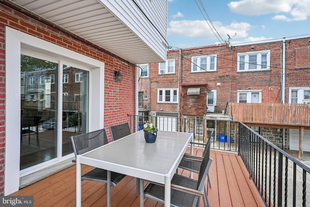 wooden terrace featuring outdoor dining space