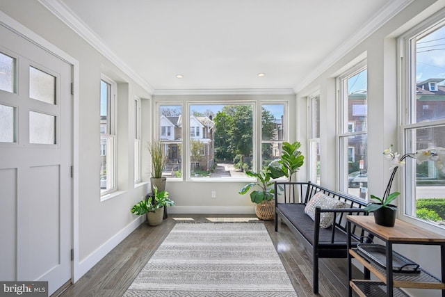 sunroom / solarium with baseboards, recessed lighting, crown molding, and wood finished floors