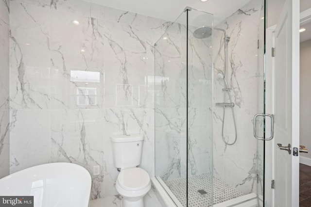 full bathroom with tile walls, recessed lighting, toilet, a freestanding bath, and a marble finish shower