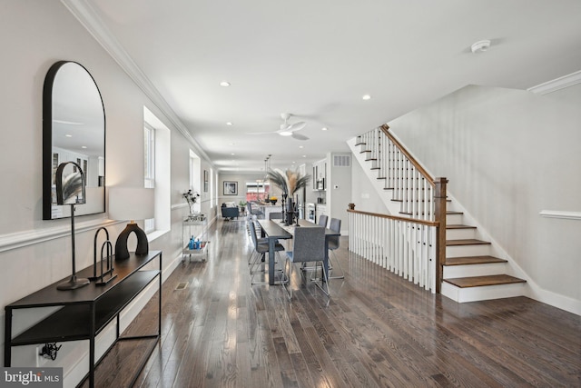 dining room with visible vents, ceiling fan, crown molding, wood finished floors, and stairway