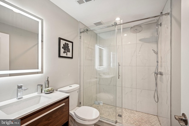 full bath featuring toilet, vanity, visible vents, and a marble finish shower