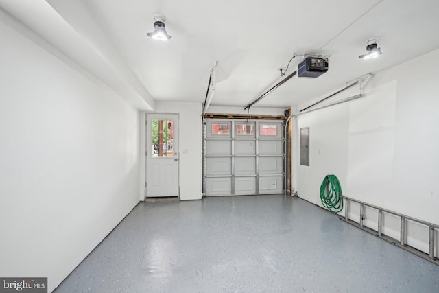 garage featuring electric panel and a garage door opener