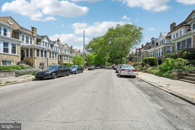 view of road with curbs, sidewalks, and a residential view