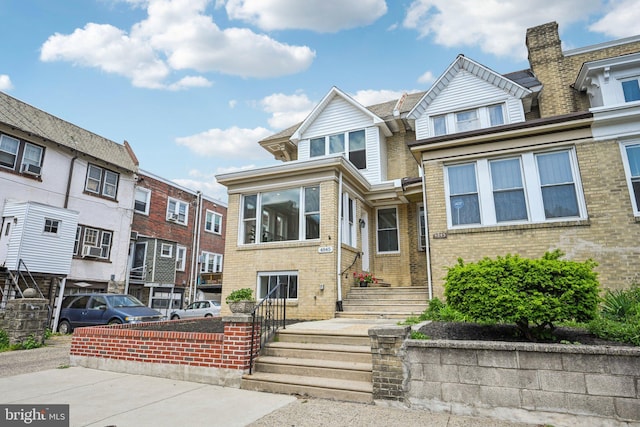 view of property with brick siding and a residential view