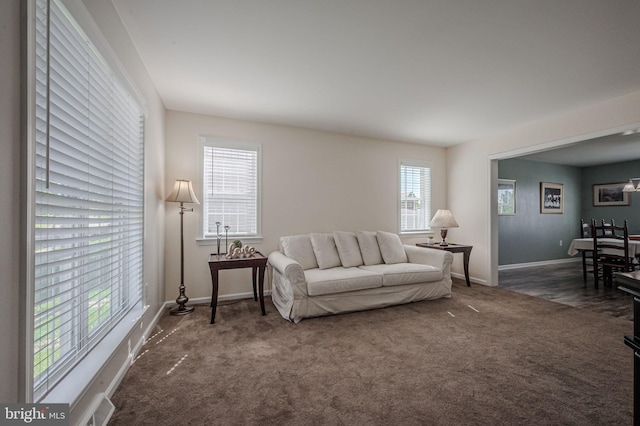 living room featuring carpet flooring, baseboards, and visible vents