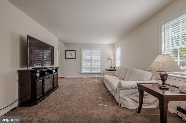 carpeted living area with baseboards
