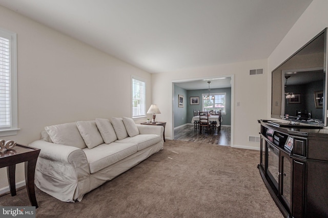 living area with carpet flooring, baseboards, and visible vents