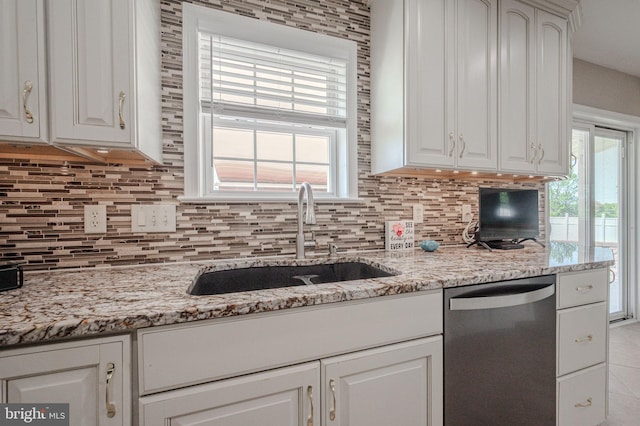 kitchen with a sink, white cabinetry, backsplash, and dishwasher