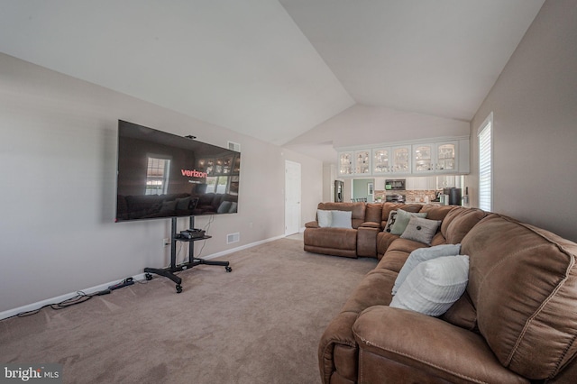 living area featuring baseboards, visible vents, carpet floors, and lofted ceiling