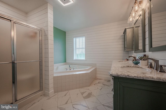 bathroom featuring a sink, marble finish floor, a bath, and a shower stall