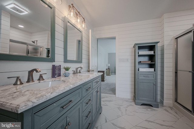 bathroom with a sink, marble finish floor, and wooden walls
