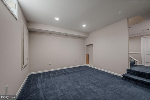 basement featuring recessed lighting, baseboards, and dark colored carpet