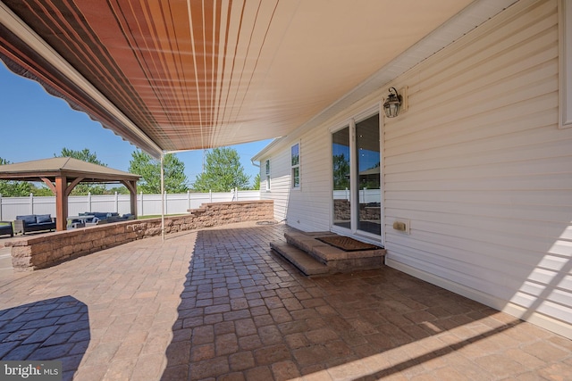 view of patio with a gazebo and fence