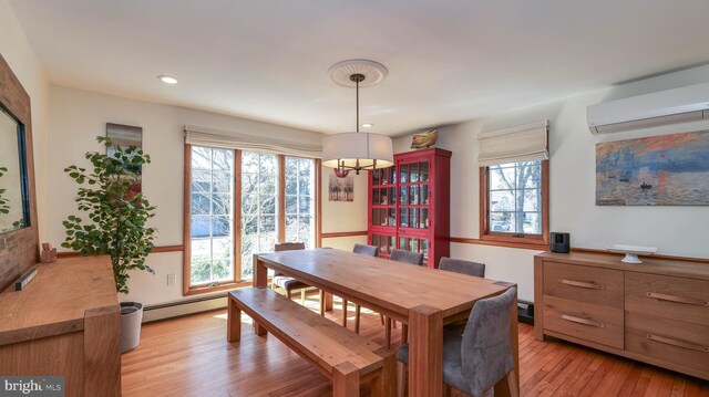 dining space with a wall mounted AC, recessed lighting, a baseboard heating unit, a notable chandelier, and light wood-type flooring