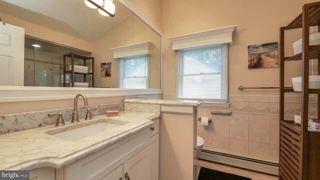 full bath featuring toilet, lofted ceiling, baseboard heating, a stall shower, and vanity