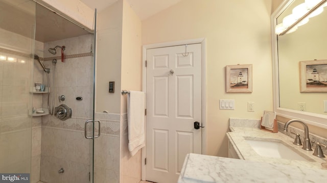 bathroom featuring vanity and a shower stall