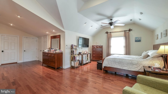 bedroom featuring baseboards, lofted ceiling, and wood finished floors
