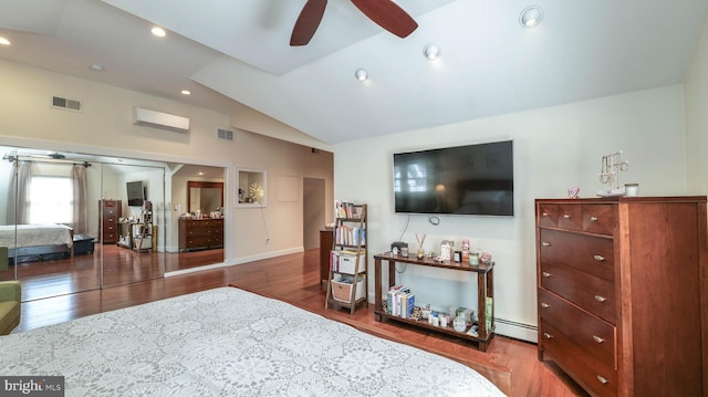 bedroom with wood finished floors, visible vents, vaulted ceiling, an AC wall unit, and a baseboard heating unit