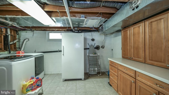 below grade area with washer / dryer and freestanding refrigerator