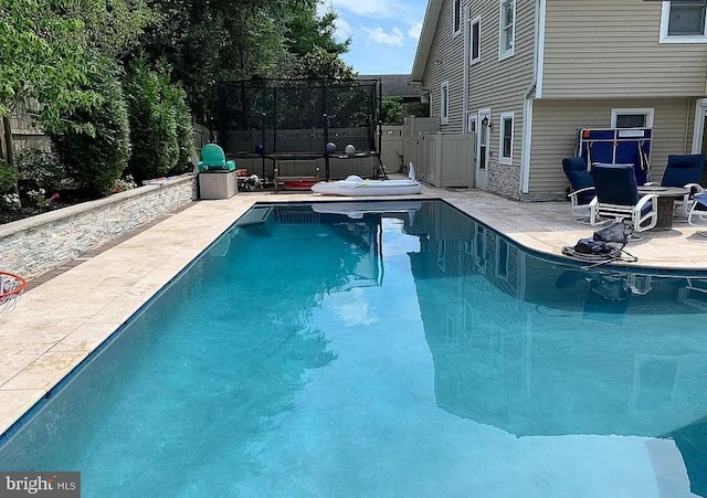 view of pool with a fenced in pool, fence, and a patio area