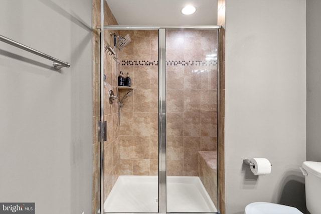 full bathroom featuring recessed lighting, toilet, and a stall shower