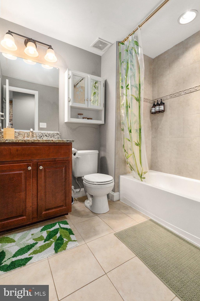 full bath with tile patterned floors, shower / bath combo with shower curtain, visible vents, and toilet