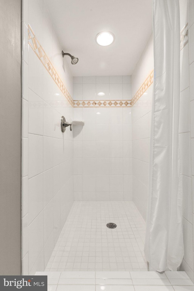 full bathroom with a tile shower