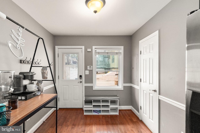 entryway with baseboards and wood finished floors