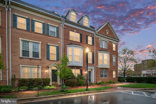 townhome / multi-family property with brick siding