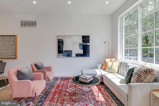 living area featuring recessed lighting, wood finished floors, visible vents, and baseboards