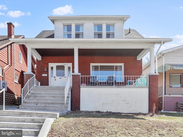 433 Williams St, Cumberland, MD 21502 - view of front facade with brick siding, a porch, a shingled roof, and central AC unit