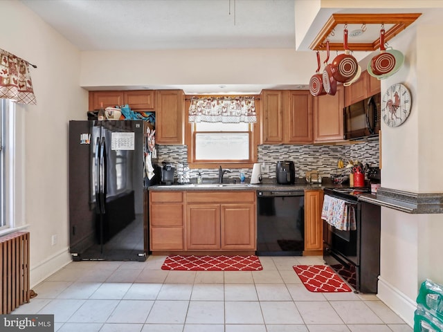 433 Williams St, Cumberland, MD 21502 - kitchen with a sink, black appliances, radiator heating unit, and dark countertops