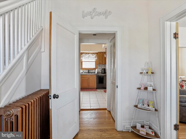 433 Williams St, Cumberland, MD 21502 - hall featuring radiator heating unit and light wood-style flooring