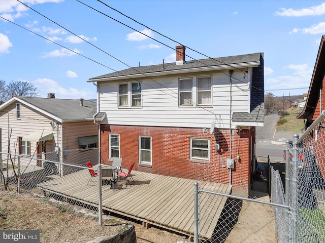 433 Williams St, Cumberland, MD 21502 - back of house with a chimney, a fenced backyard, a deck, brick siding, and a shingled roof